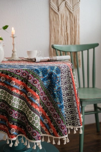 Detail of bohemian round tablecloth with geometric mandala prints and white fringe trim