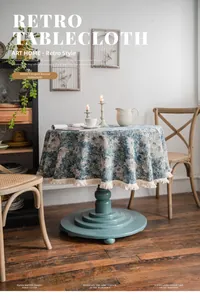 Detailed close-up of retro blue floral jacquard round tablecloth with white tassel edges