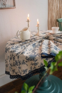 Detail of blue floral cotton linen tablecloth with vintage crochet lace border