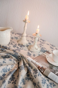 Detailed close-up showing the soft drape and blue floral pattern on cotton linen fabric