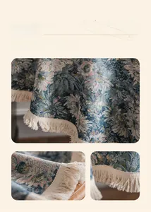 Detail of blue floral jacquard tablecloth with elegant beige tassel fringe edges