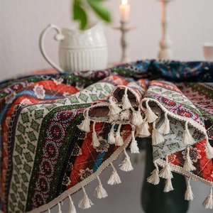 Bohemian ethnic style tablecloth with colorful stripes and decorative beige tassels