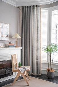 Macro detail of striped cotton linen curtain with tassel fringe and vertical texture