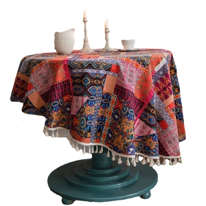 Bohemian round tablecloth with colorful geometric patterns and white fringe edges