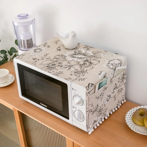 Detail of microwave dust cover featuring black rose prints and side storage pockets
