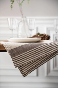 Detail showing natural linen texture and brown striped pattern on a quality table runner