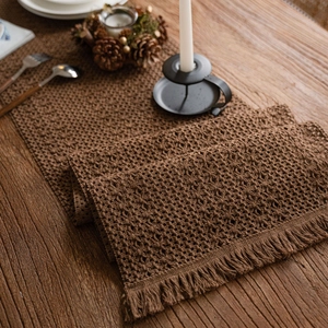 Handmade brown crochet table runner with hollow floral pattern and elegant long tassels