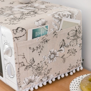 Linen microwave dust cover with black floral pattern and side storage pockets