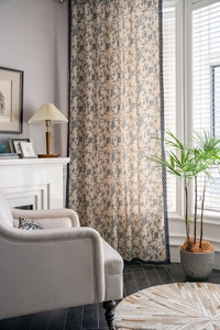 Detail view of blue floral cotton linen curtain with delicate lace trim on the side