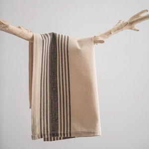 Linen cotton striped napkin displayed on natural wood branch for food photography styling
