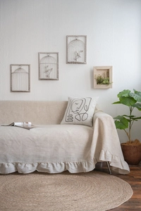 Detailed texture of beige ruffled sofa cover in minimalist Japandi style living room