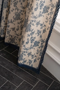 Detail of blue floral cotton linen curtain featuring elegant crochet lace edge trim
