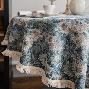 Blue vintage floral jacquard round tablecloth with tassels on elegant dining table