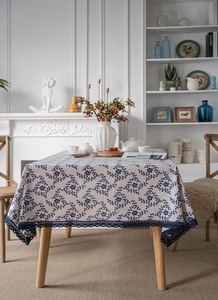 Close-up of vintage cotton linen tablecloth with navy floral print and lace crochet edge