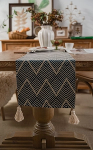 Detailed view of dark blue geometric jacquard table runner with cotton fringe tassels