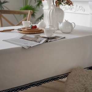 Elegant white cotton linen tablecloth with delicate black lace trim for home dining tables