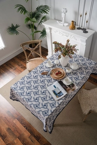 Detail of navy floral print tablecloth with elegant scalloped lace edges on premium cotton linen