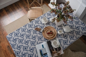 Detail of navy blue plum floral linen tablecloth with elegant lace edge texture