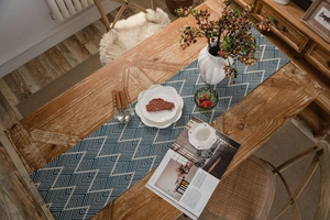 Detail view of blue and white geometric herringbone pattern on a modern long table runner