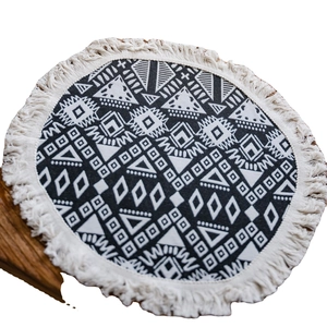 Bohemian round table runner with black and white geometric jacquard pattern and tassels