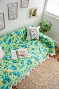 Detail of green floral sofa cover with white ruffles in oil painting aesthetic style