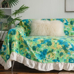 Floral green sofa cover with abstract print and vintage white ruffled edge trim