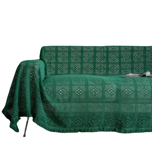 Dark green crochet sofa throw with diamond grid patterns and vintage tassel edges