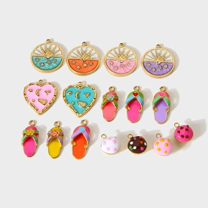 Detailed macro view of mixed colorful enamel charms including slippers and heart shapes