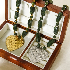 Green acrylic beaded necklace with hammered heart pendant in gold and silver finish