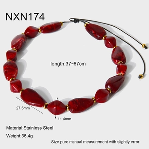 Detailed view of red acrylic beads with golden stainless steel spacers and adjustable cord