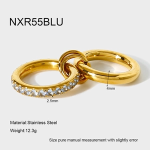 Macro detail of interlocking gold rings with cubic zirconia and stainless steel textures