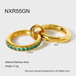 Detail of 18K gold stainless steel interlocking rings with 2.5mm green zircon stones