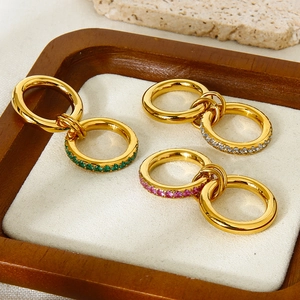 Detailed close-up of double-layer gold rings with colorful zircon inlays on a tray
