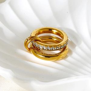 Detail view of 18K gold plated interlocking rings with sparkling cubic zirconia on tray
