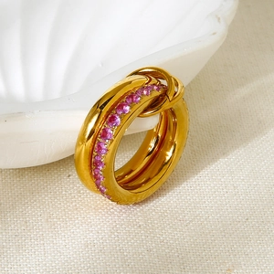 Detailed macro view of gold-plated double-layer ring featuring pavé pink cubic zirconia
