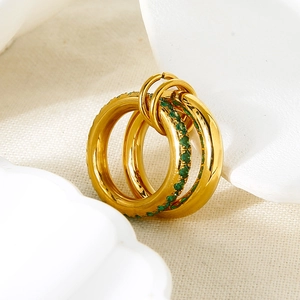 Macro shot of 18K gold double hoop earrings featuring pavé-set green cubic zirconia stones