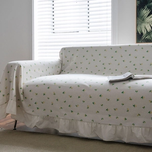 Floral lemon print sofa cover with elegant ruffle edges for a fresh home decor style
