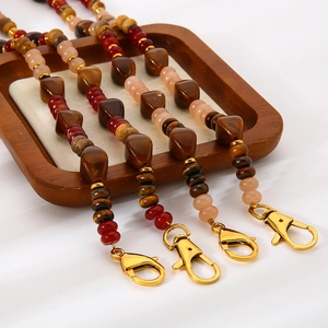 Macro detail of multi-use handmade beaded chain with natural stone and golden clasp