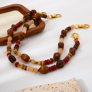 Acrylic and natural stone beaded chain with large gold lobster clasps on white background