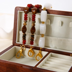 Detailed close-up of acrylic and natural stone beads on multi-use gold clasp charms