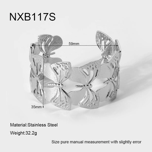 Detailed macro view of butterfly cutout patterns on this wide stainless steel cuff bracelet