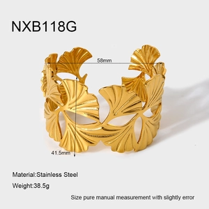 Detailed view of golden stainless steel open cuff bangle with ginkgo leaf pattern