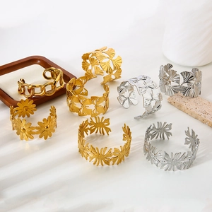 Gold and silver stainless steel open bangles with floral, leaf, and chunky chain designs