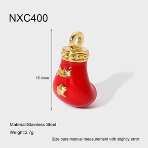 Detailed view of red enamel Christmas stocking pendant in 18K gold plated stainless steel