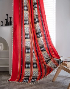 Detailed view of red Bohemian cotton linen curtain with geometric patterns and fringe
