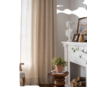 Beige cotton linen curtain with vintage crochet lace and tassels in elegant room setting
