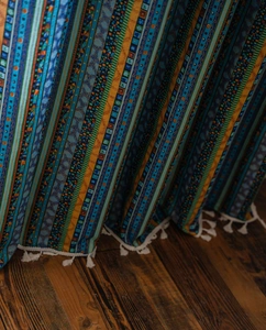 Detail of bohemian yellow striped cotton linen curtain with white fringe tassels