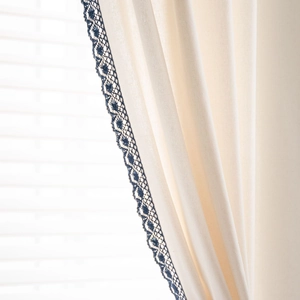 Beige cotton linen curtain with navy blue floral lace trim and elegant drape detail