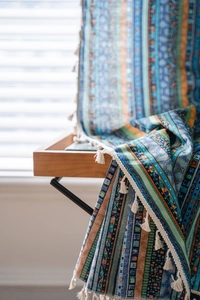 Detailed macro view of bohemian striped cotton linen fabric with artisanal tassels