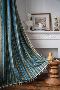 Detail of bohemian striped cotton linen curtain with colorful geometric patterns and tassels